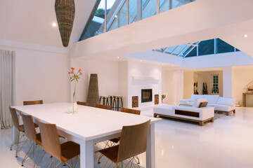 Dining table, sofas skylights in open dining living area of modern house