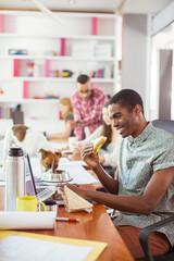 Man eating and working at conference tablet