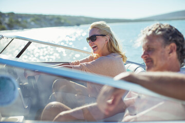 Couple driving boat in water 