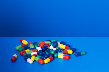 Pile of prescription pills on blue counter