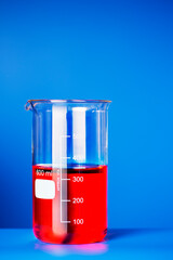 Close up of beaker of solution on blue counter