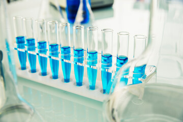 Rack of test tubes with solution on counter in lab