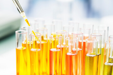 Close up of scientist pipetting solution into test tubes in lab