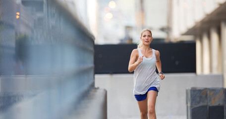 Woman running through city streets 