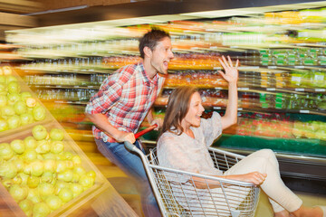 Blurred view of couple playing in grocery store