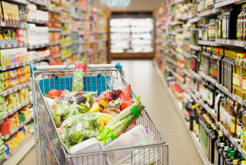 Close up of full shopping cart in grocery store