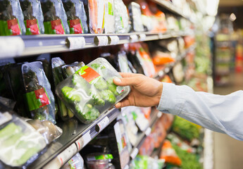 Close up of man holding produce in grocery store