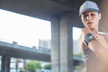Fototapeta premium Woman playing music before exercising