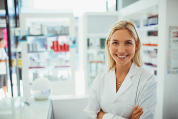 Pharmacist smiling in drugstore