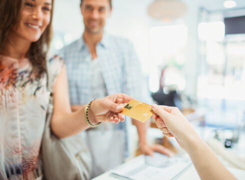 Close up of woman paying with credit card in store