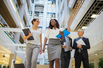 Business people walking together in office building