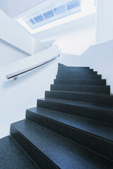 Black and white winding staircase of office building curving