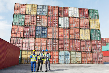 Worker and businessmen talking near cargo containers