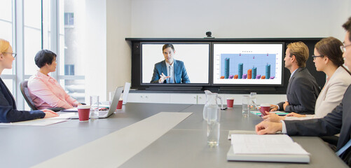 Business people using teleconference in meeting