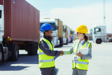 Worker businesswoman shaking hands near trucks cargo containers