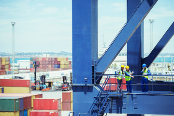 Business people and worker talking on cargo crane