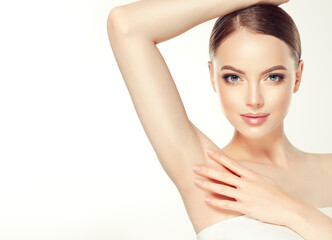 Armpit epilation, lacer hair removal. Young woman holding her arms up and showing clean underarms,...