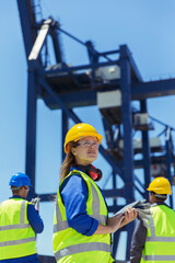 Low angle view of worker standing near cargo crane