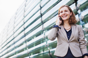 Businesswoman talking on cell phone outdoors