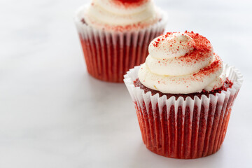 Two Red Velvet Cupcakes on Marble