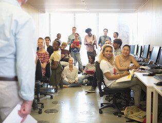University students listening to presentation in IT classroom