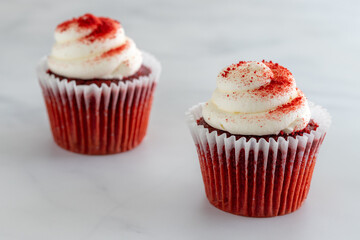 Two Red Velvet Cupcakes on Marble