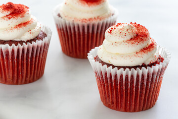 Three Red Velvet Cupcakes on Marble