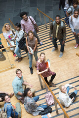 Portrait of university students standing on staircase