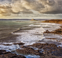 Scenic view of seaside landscape with waves crashing on rocky beach 