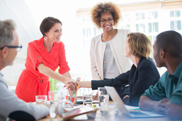 Fototapeta premium Office workers shaking hands at desk