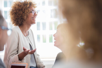 Office workers talking at meeting