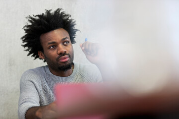 Focused university student listening during seminar in classroom