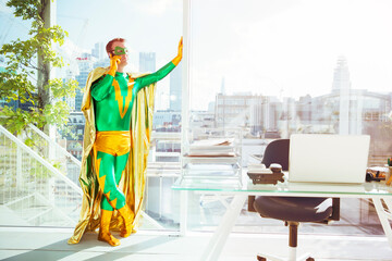 Superhero talking on cell phone in office