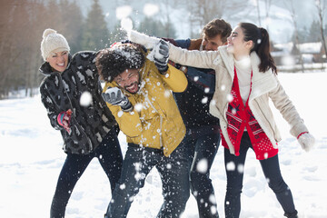 Friends enjoying snowball fight