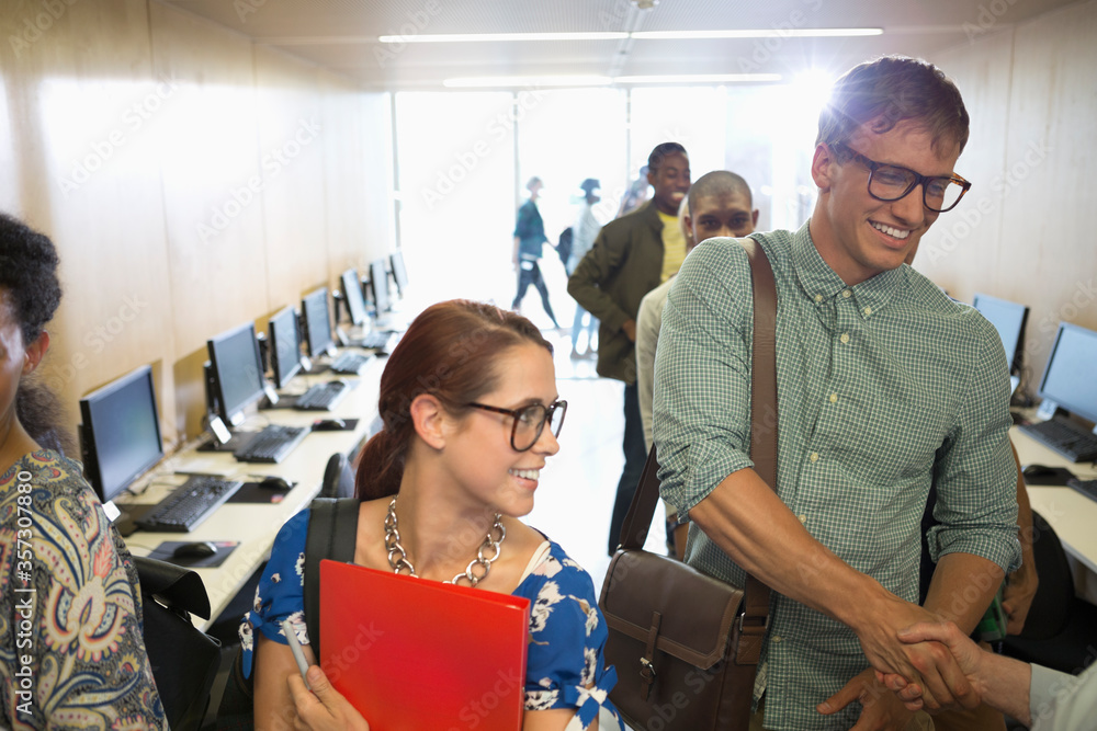 Wall mural professor greeting university students in classroom