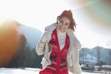 Smiling woman in snowy field