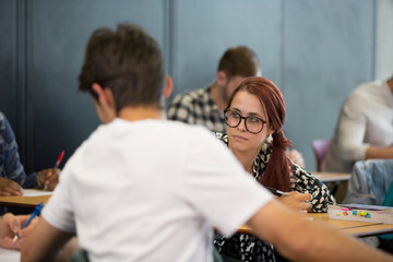 University students taking notes during seminar