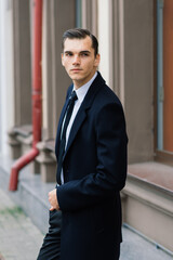 Man in a stylish suit. Businessman in an autumn city, fashion