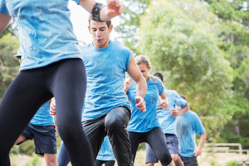 Determined man on boot camp obstacle course