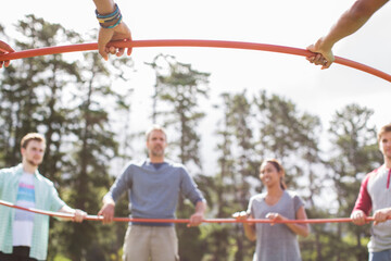 Team connected in circle around plastic hoop