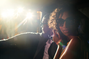 Portrait of celebrity couple in limousine arriving at event