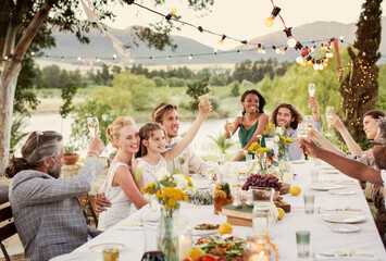 Young couple guests toasting champagne during wedding reception in domestic garden - obrazy, fototapety, plakaty