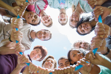 Portrait of team connected in circle around plastic hoop