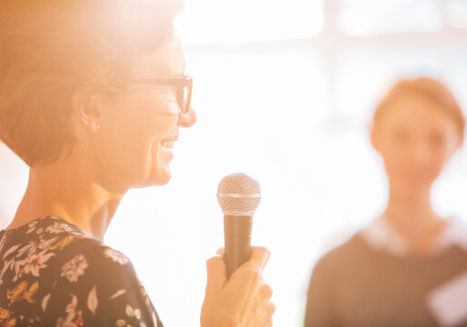 Close up woman speaking with microphone