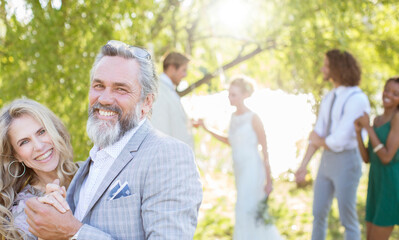 Matron of honor dancing best man during wedding reception in domestic garden