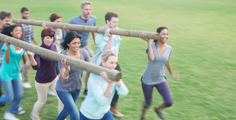 Teams racing with logs in field - obrazy, fototapety, plakaty