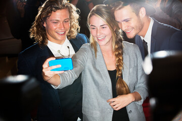 Fan taking selfie with celebrities at event