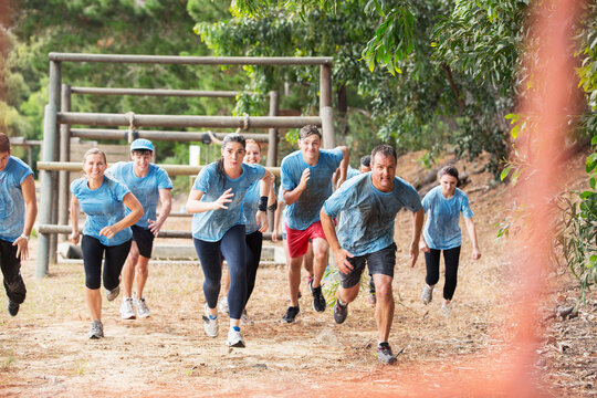 Team running on boot camp obstacle course - Powered by Adobe