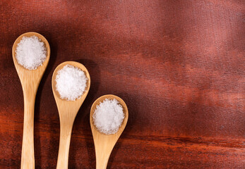 Magnesium chloride in three wooden spoons - Text space
