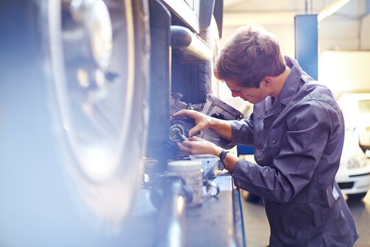 Mechanic examining part in auto repair shop